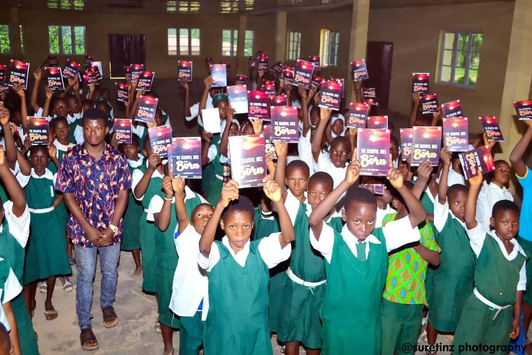 Students celebrating with distributed books